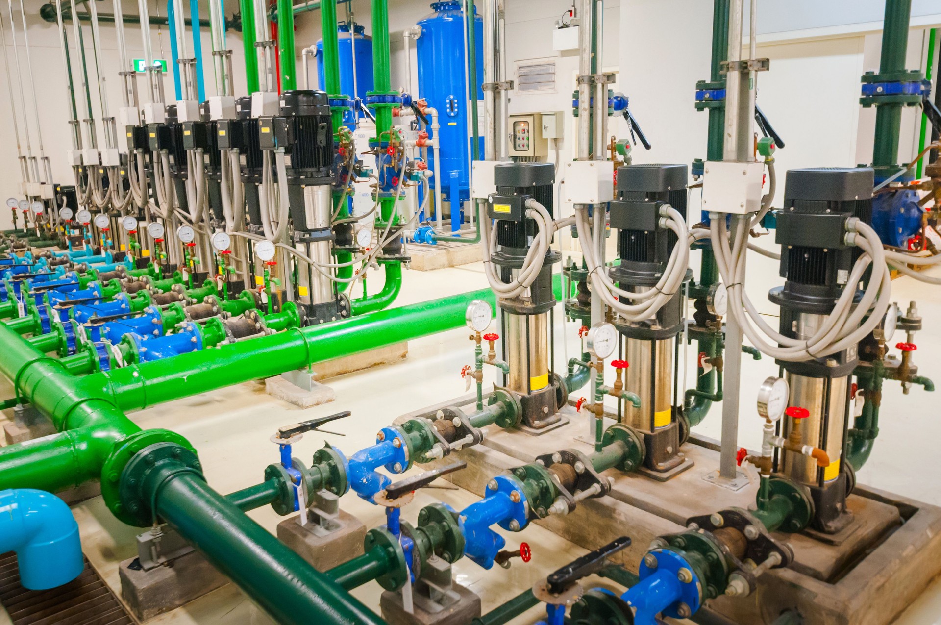 Industrial piping of different colors inside a warehouse